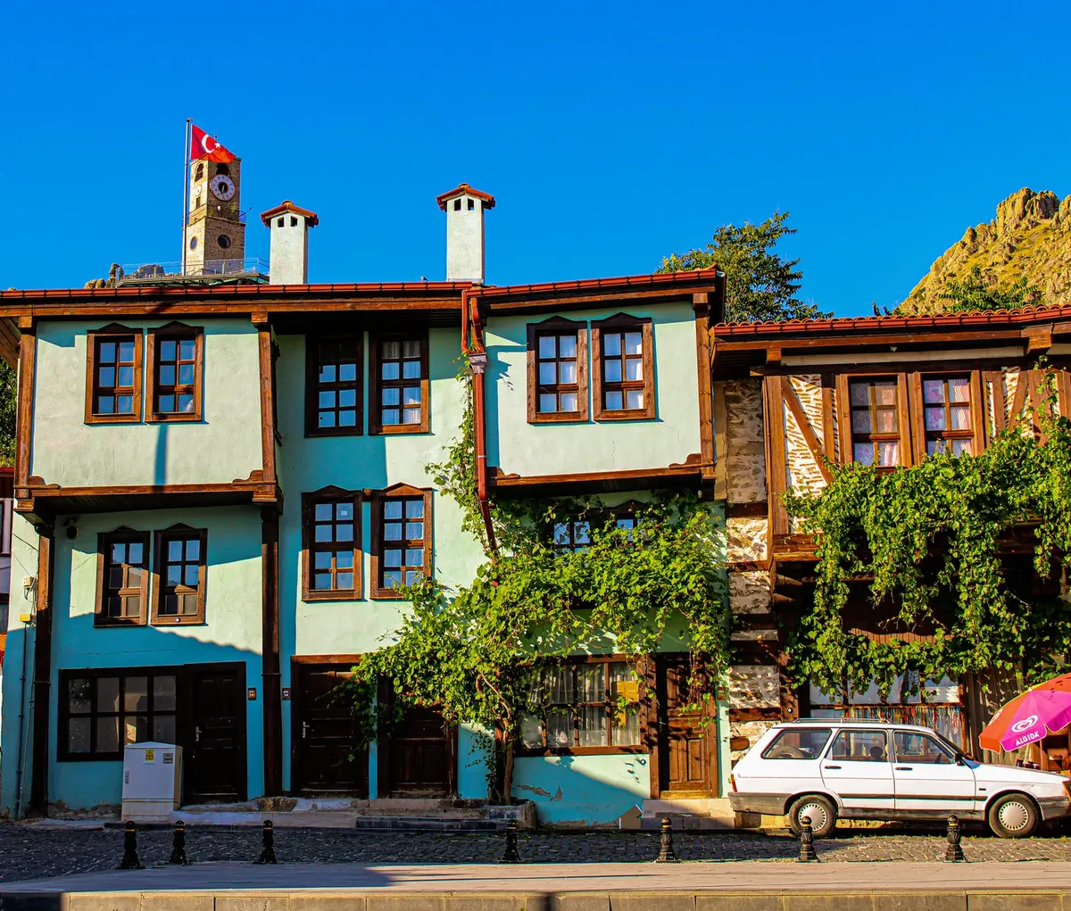 Charming townhouses with half-timbered architecture in Sivrihisar, Turkey under clear skies.