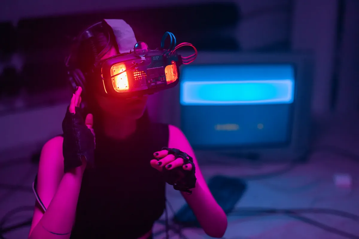 A woman immerses in virtual reality with neon-lit goggles and gloves in a tech-savvy environment.